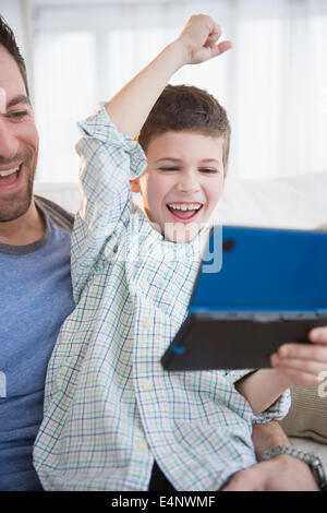 Father and son (8-9) playing video game Stock Photo