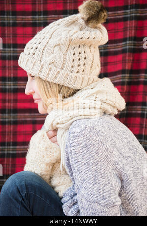 Profile of woman wearing knit hat and scarf Stock Photo