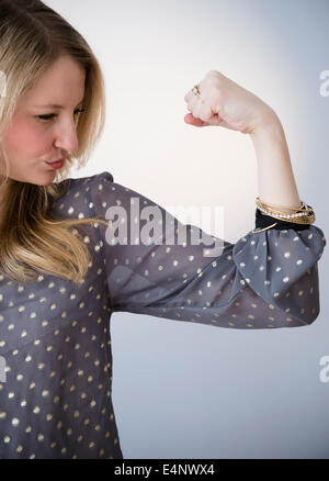 Portrait of blond woman showing muscle Stock Photo