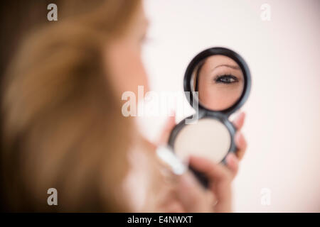 Woman applying makeup Stock Photo