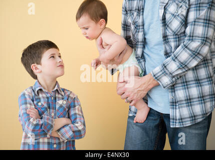 Father with his children (6-11 months, 8-9) Stock Photo