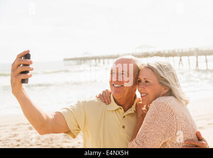 USA, Florida, Jupiter, Senior couple taking picture of themselves on beach Stock Photo