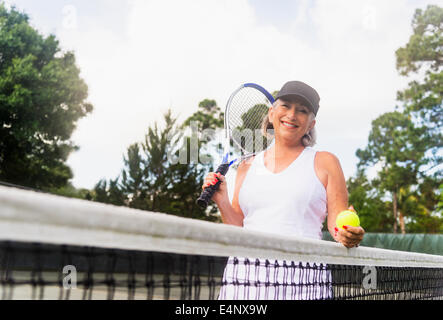 USA, Florida, Jupiter, Portrait of senior woman on tennis court Stock Photo