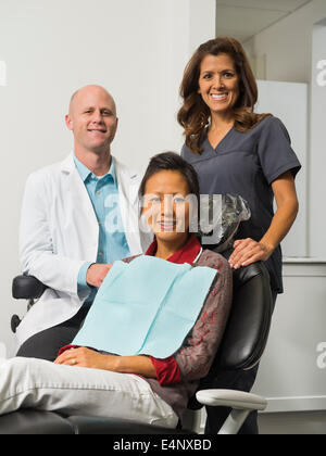 Portrait of dentist with patient and assistant Stock Photo