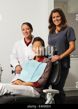 Portrait of dentist with patient and assistant Stock Photo