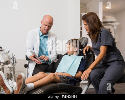 Dentist holding digital tablet with patient's (12-13) x-ray Stock Photo
