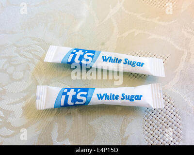 Two sachets of white sugar in a café for sweetening tea Stock Photo