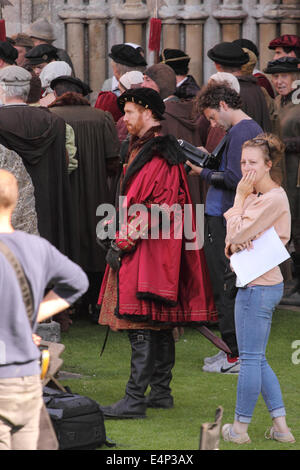 Wells, Somerset, UK. 15th July, 2014. The BBC are filming a new drama called 'Wolf Hall' based on the book by Hilary Mantel. The six part series focuses on the politics of despotism between King Henry VIII and Thomas Cromwell. Actor Damian Lewis plays King Henry VIII shown here. Filming took place at Wells Cathedral today and the series will be screened in early 2015. Stock Photo