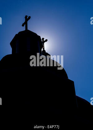Daylight Buggy Stars. Insects shine like stars in this afternoon silhouette of the crosses and domes of the Ukrainian Cathedral Stock Photo