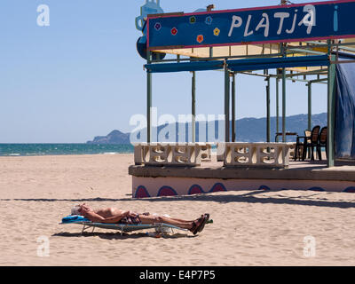 Naked man sunbathing on sun bed alone on Skiathos Greek island Stock
