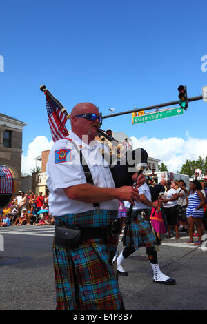 Bagpiper of Greater Baltimore Fire Brigade Pipes and Drums Highland Band parading during July 4th Independence Day parades, Catonsville, Maryland, USA Stock Photo