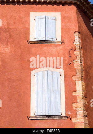 Details from a Shuttered House in Roussillon. Characteristic building in Roussillion. The red stucco finish affectedly broken. Stock Photo