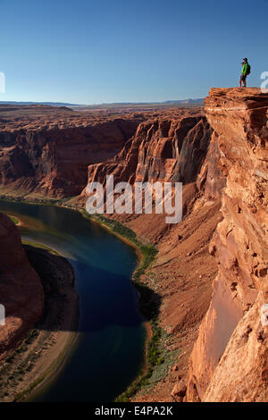 Tourists looking at 1000 ft drop down to Colorado River at Horseshoe Bend, just outside Grand Canyon, near Page, Arizona, USA Stock Photo