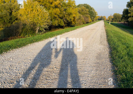 Shadow of a Couple on the Dirt Road in the Nature Stock Photo