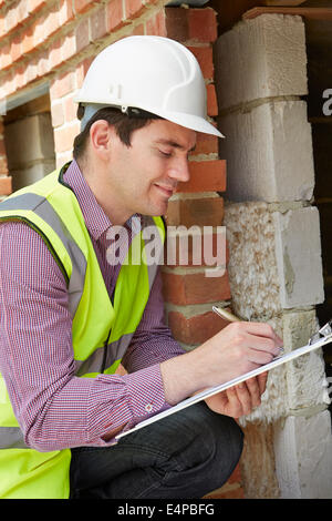 Architect Checking Insulation During Construction Project Stock Photo