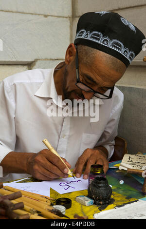 Calligrapher in the Ulugbek Madrasah, Registan, Samarkand, Uzbekistan Stock Photo