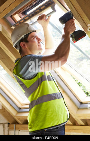 Construction Worker Using Drill To Install Window Stock Photo