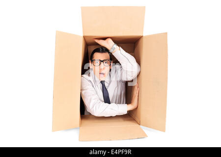 Young businessman trapped in a box Stock Photo