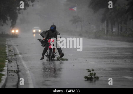 Manila, Philippines. 16th July, 2014. A motorist brave strong winds and rain as he travels along a highway as Typhoon Rammasun barrels across Manila on July 16, 2014. Typhoon Rammasun shut down the Philippine capital on July 16 as authorities said the first major storm of the country's brutal rainy season claimed at least four lives and forced hundreds of thousands to evacuate. Credit:  George Calvelo/NurPhoto/ZUMA Wire/Alamy Live News Stock Photo
