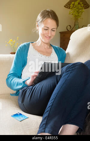 Attractive brunette woman using a tablet computer. Stock Photo