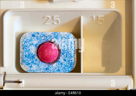 Finish Classic dishwasher tablet in soap compartment of dishwasher. Stock Photo