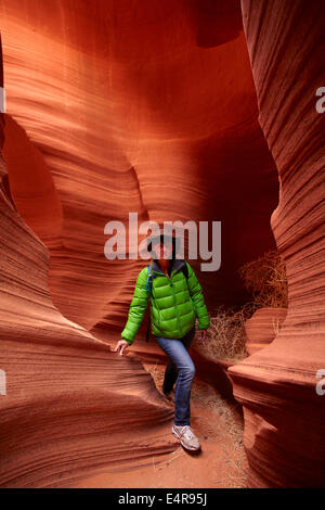 Tourist and eroded sandstone formations in Rattlesnake Canyon, near Page, Navajo Nation, Arizona, USA Stock Photo