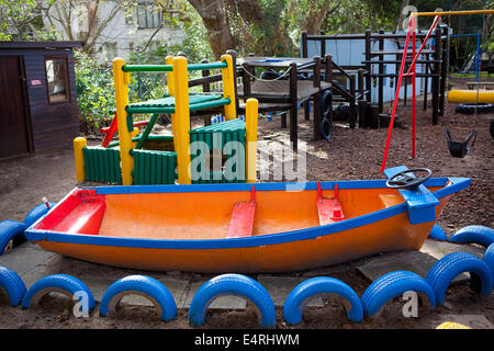 Pre-primary school playground boats and swings Stock Photo