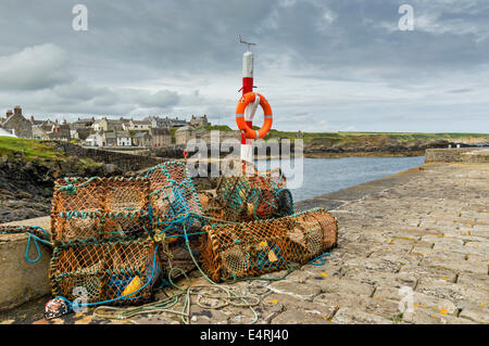 CRAB OR LOBSTER CREELS ON PORTSOY STONE HARBOUR WALLS ABERDEENSHIRE COAST SCOTLAND Stock Photo