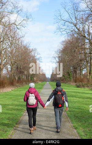 couple holding hands walking in a mall Stock Photo