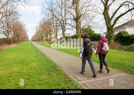 couple holding hands walking in a mall Stock Photo