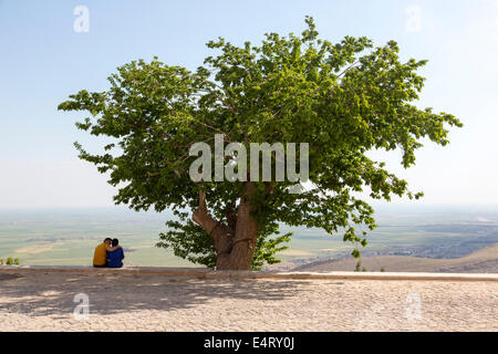 amorous couple beside tree, Mardin, Turkey Stock Photo