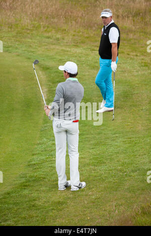 Rory Mcilroy and Darren Clarke practicing golf chipping around the green fringe at Royal Liverpool on Practice Day of British Open Golf Championship, Hoylake, UK 2014 Stock Photo