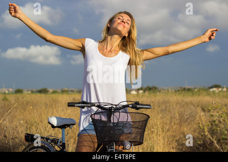 young beautiful blond girl woman relaxing  free freedom countryside bicycle nature outdoor natural beauty 'white t-shirt' Stock Photo