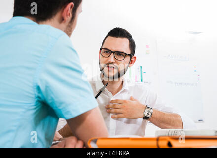 Close-up of two young businessmen meeting and in discussion, Germany Stock Photo