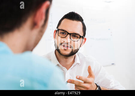 Close-up of two young businessmen meeting and in discussion, Germany Stock Photo