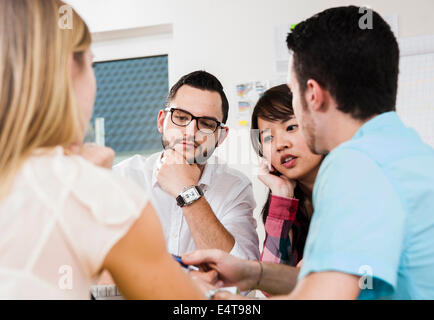 Close-up of group of young business people meeting and in discussion, Germany Stock Photo