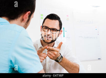 Close-up of two young businessmen meeting and in discussion, Germany Stock Photo