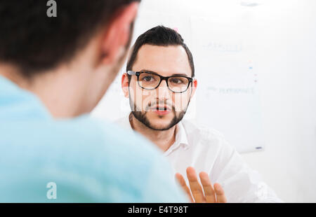 Close-up of two young businessmen meeting and in discussion, Germany Stock Photo