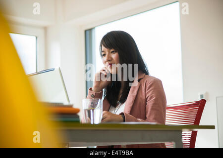 Young Businesswoman Working in Office, Mannheim, Baden-Wurttemberg, Germany Stock Photo