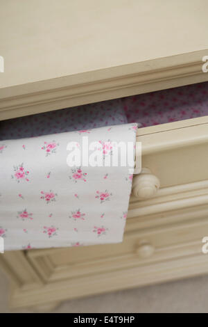 Baby Blanket draped over Open Dresser Drawer in Nursery Stock Photo