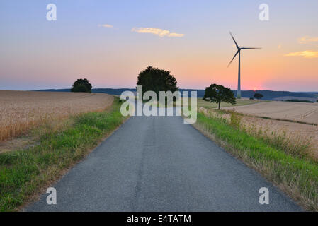 Countryside with Forked Road and Wind Turbine at Dusk, Bad Mergentheim, Baden-Wurttemberg, Germany Stock Photo