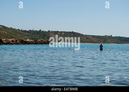 Fisherman in the sea Greece Stock Photo