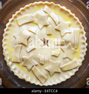 Overhead view of unbaked apple pie with star shaped cut-outs on top, studio shot Stock Photo