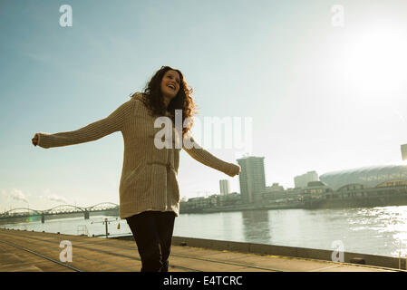 Teenage girl outdoors, standing next to river at loading dock, Mannheim, Germany Stock Photo