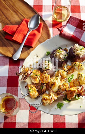 Overhead View of Seafood Kebobs and Stuffed Onions at Picnic Stock Photo