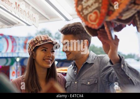 Close-up of young couple having fun at amusement park, Germany Stock Photo