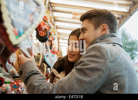 Close-up of young couple having fun at amusement park, Germany Stock Photo