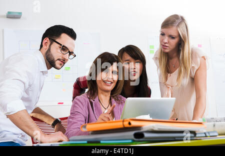 Mature businesswoman meeting and in discussion with group of young business people, Germany Stock Photo