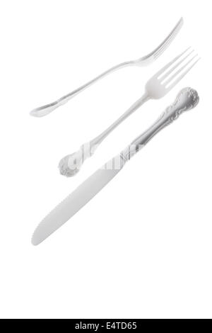 Two fancy white plastic forks and one fancy white plastic knife on a high key white background. Stock Photo