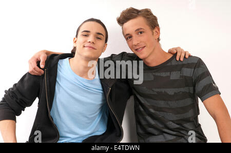 Studio portrait of smiling man with two cats Stock Photo - Alamy